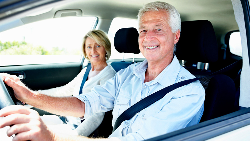 senior citizen couple in car